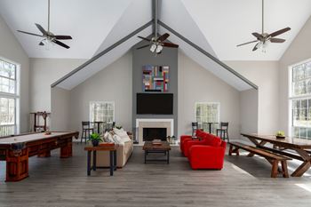 Clubhouse features a seating area and tv, along with a pool table.